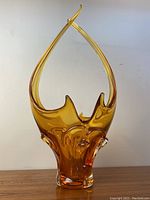 Front view of the vintage amber glass chalet art glass centrepiece showing its tall elongated shape and warm amber color.