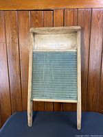 Full view of the vintage wooden washboard displaying wooden frame and textured glass wash surface.