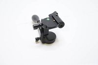 Front view of black camera tripod head showing handle, bubble level, and mounting area.