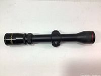 Full side view of the Excalibur Vari Zone 2-4x32 scope showing the entire length and mounting setup.