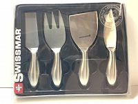 Front view of Swissmar 4-piece petite cheese utensil set in clear plastic packaging, showing all 4 stainless steel utensils.