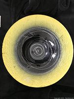 Top view of the glass bowl platter showing the gold textured outer rim and black center with white spiral design.