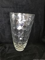 Front view showing the large, clear glass vase with a raised honeycomb pattern covering the entire body. Vase is thick and substantial in weight.