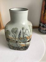 Front and side views of the vintage Royal Copenhagen Fajance pottery vase, showing detailed hand-painted riverside scenery, glazed surface, and square form with narrow neck.