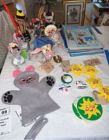 Photo of the lot showing multiple Annalee dolls, felt mouse puppet, stickers and magazines arranged on a table.