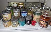 Photo showing multiple Yankee Candle jars, votive candles, and fragrance spheres in various scents and colors.