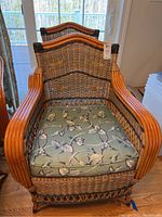 Front view of chair with green floral cushion in place