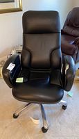 Front view of black leather Concorde executive office chair with padded seat and high backrest.