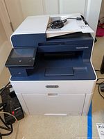 Front view of Xerox WorkCentre 6515 multifunction printer showing touchscreen panel and top automatic document feeder.