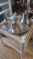 Full view of the tea set on a chair showing all pieces on the tray