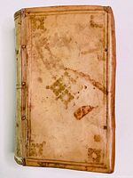Full front cover of vellum-bound volume with gilt-stamped decorative motifs and visible age marks