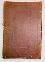 Front cover of the volume showing a plain brown hardcover with embossed patterns, some wear and tear, and detached edges.