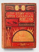 Front cover detail of 1885 hardcover book with red gilt embossed ornate design and title