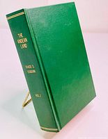 Angled view of the spine and front cover of the hardcover book showing the title, author, and volume number on the spine in gold lettering.