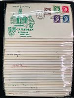 Stack of Canadian first day covers, each with multiple postage stamps and postmarks, showing the variety and condition of the covers.