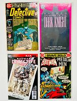 Four Batman-themed comics freshly bagged and boarded, shown together.