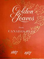 Close-up of orange softcover portfolio with gold leaf decoration and title text.
