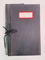 Photo of one gray binder with tie closure and label on front covering Toronto Transit Commission minutes 1920-1921