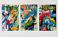 Three Venom comic books bagged and boarded, displayed side by side.