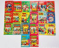 Top view of 20 vintage Archie comic digests laid out in rows, showing colorful covers featuring classic Archie characters and different titles.