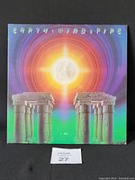 Front gatefold jacket cover of Earth, Wind & Fire 'I Am' album showing detailed cosmic and architectural artwork with band name and album title.