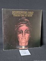Front cover of 1972 Steppenwolf Gold Their Great Hits vinyl album featuring a stylized female face with makeup and chains