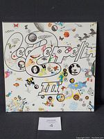 Front cover of Led Zeppelin III album jacket with colorful illustrations and band logo.