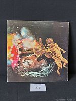 Front cover of 1971 Santana vinyl album showing abstract cosmic artwork with human figure, with some wear and scuffs visible on the jacket