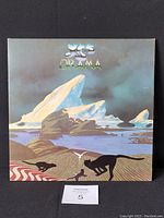 Front view of vinyl record jacket showing illustrated landscape design with animals and icebergs under a cloudy sky. Condition visible with corner and ring wear.