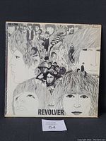 Front cover of The Beatles Revolver vinyl LP showing the original illustrated artwork and shrink wrap.