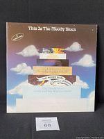 Front cover of The Moody Blues 1974 gatefold album with layered previous album art design and clouds background