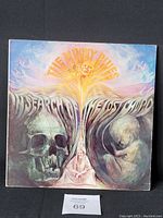 Front cover of The Moody Blues 1968 album "In Search of the Lost Chord" showcasing psychedelic artwork with skulls and a fetus.
