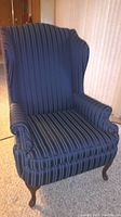 Front view of the blue striped wingback chair.