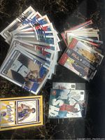Photo showing a group of basketball cards including base cards and inserts featuring players like Cade Cunningham and others with various designs and colors.