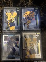 Eight NHL cards featuring Vancouver Canucks players, including Roberto Luongo, Quinn Hughes, Pavel Bure, and the Sedin twins. Cards from Upper Deck Black Diamond series and others.