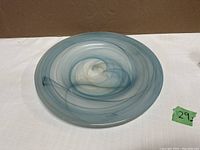 Top angled view showing swirling blue and white pattern on dish and smooth surface quality.