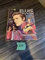 Front cover of the collector book showing colorful artistic illustrations of Elvis Presley.