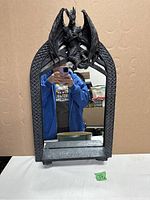 Front view of gothic dragon mirror showing the dragon perched at the top and mirror surface, with shelf below.