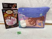 Photo showing Comfort Pedic Toasty Hands mittens box and Lower Back Wrap sealed in original packaging on a plain white background.