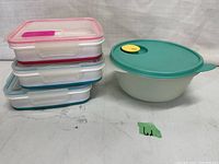 Photo of 3 Cool Gear collapsible sandwich containers stacked and Tupperware bowl with teal steam release lid.