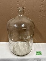 Full front view of the 5 gallon glass jug showing clear glass with no chips or cracks.