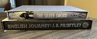 Side view of two Folio Society books showing titles The Silver Sword and English Journey by J.B. Priestley with original slip covers