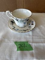 View of Royal Albert bone china tea cup and saucer with floral pattern and gold trim.