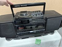 View of YORX boombox showing handle, CD player lid, and control buttons