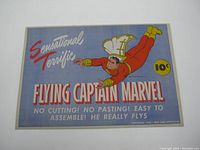Front side of the paper toy showing Captain Marvel flying illustration with price and title text.