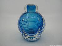 Front view of blue crystal Sommerso vase showing faceted sides and smooth neck opening.
