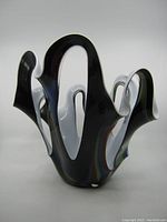 Front view of the large handblown black and white Makora glass vase with colorful swirls and sculptural organic shape.