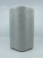 Front view of white diamond-shaped, textured flower vase with bisque finish.