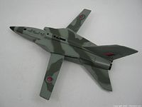 Top view of Old Dinky Toys MRCA metal plane showing camouflage paint and insignias on wings and tail.