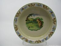 Full view of ceramic bowl showing koala and golf themed rim decoration